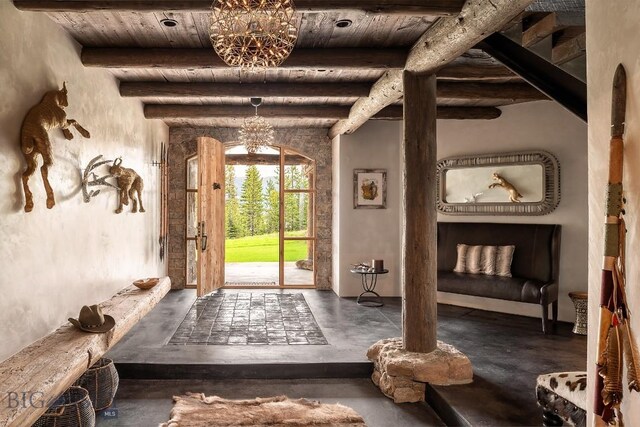 interior space featuring concrete floors, beamed ceiling, a notable chandelier, and wooden ceiling