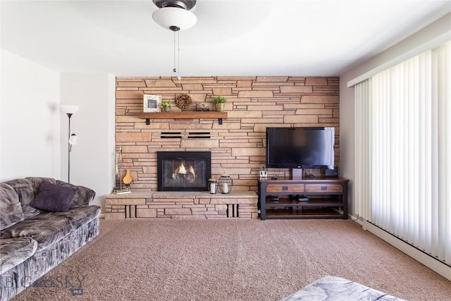 living area featuring carpet and a fireplace