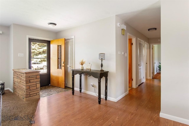 foyer with wood finished floors and baseboards