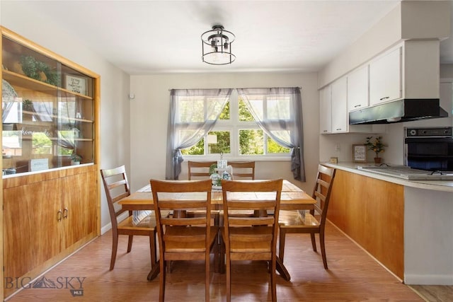 dining room with light wood-style flooring and baseboards