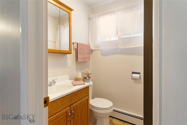 bathroom with a baseboard heating unit, vanity, and toilet