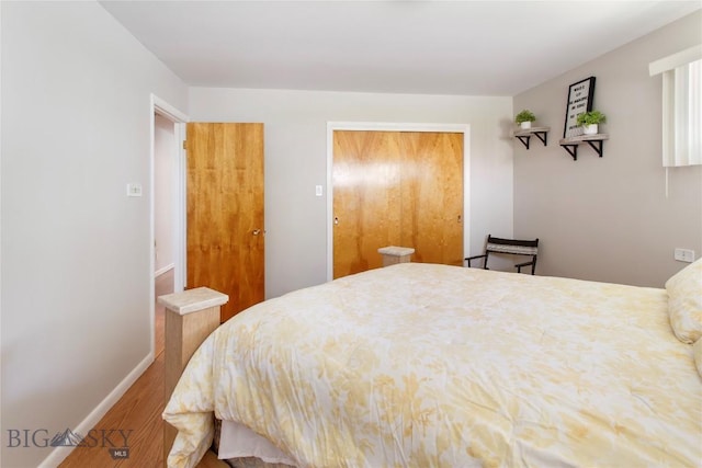 bedroom with baseboards and wood finished floors