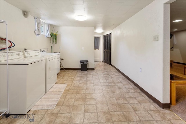 laundry room with laundry area, separate washer and dryer, and baseboards