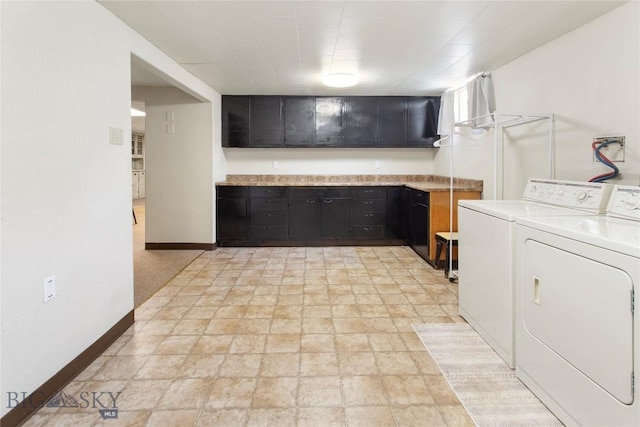 laundry room featuring stone finish floor, baseboards, and separate washer and dryer