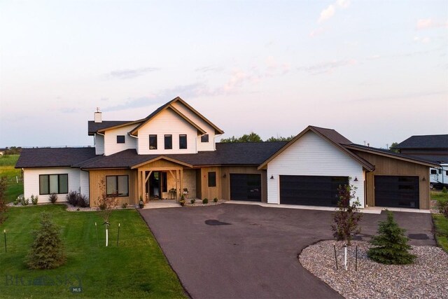 view of front of house featuring a garage and a front lawn