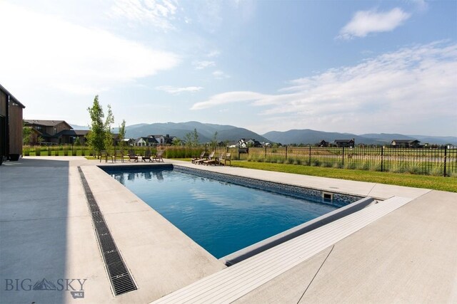 view of pool with a mountain view and a patio