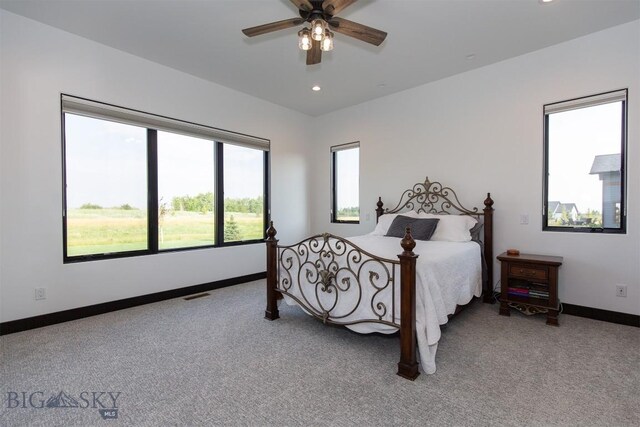 bedroom featuring multiple windows, carpet floors, and ceiling fan