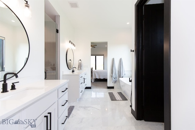 bathroom with tile patterned flooring, independent shower and bath, and vanity