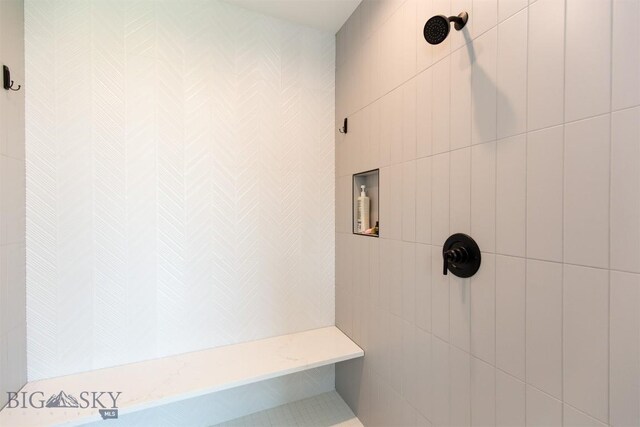 bathroom with tiled shower