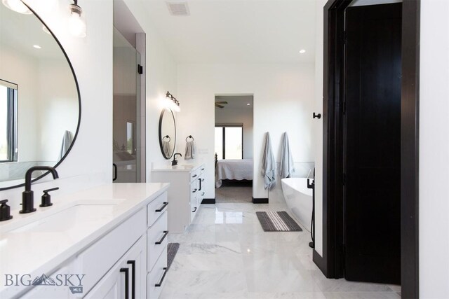 bathroom with vanity, tile patterned floors, and a tub