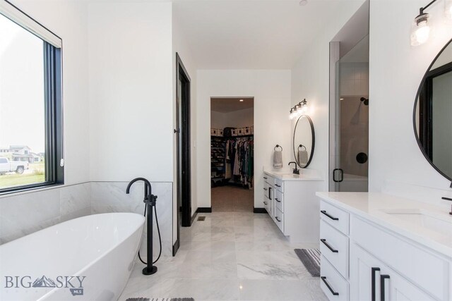 bathroom featuring vanity, tile patterned flooring, and separate shower and tub