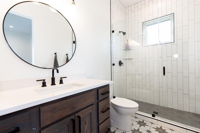 bathroom featuring vanity, walk in shower, tile patterned flooring, and toilet