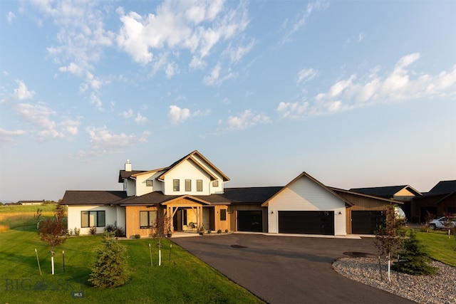 view of front of home featuring a garage and a front lawn