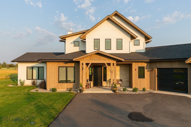 view of front of house with a garage and a front yard