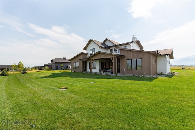 rear view of property featuring a yard