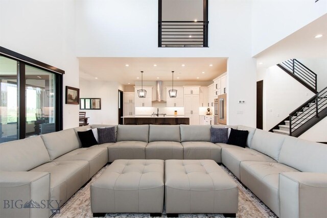 living room featuring sink and a high ceiling