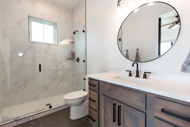 bathroom with a shower with door, tile patterned flooring, toilet, vanity, and ceiling fan