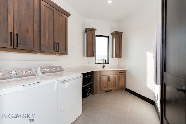 laundry room featuring sink, independent washer and dryer, cabinets, and light tile patterned floors