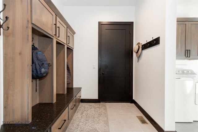 mudroom with washer / dryer and light tile patterned floors