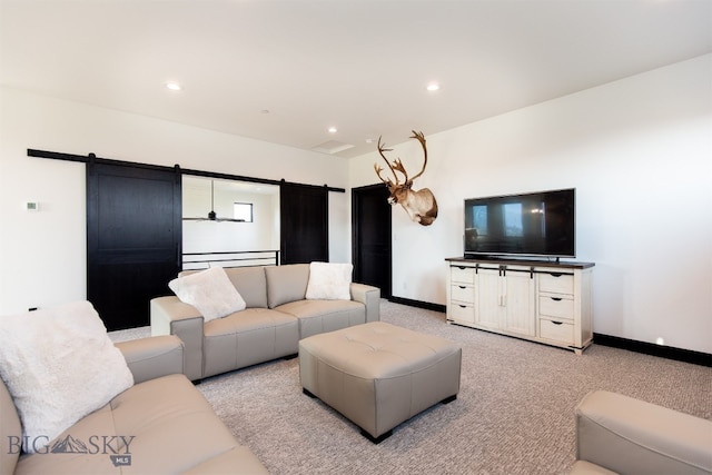 carpeted living room featuring a barn door