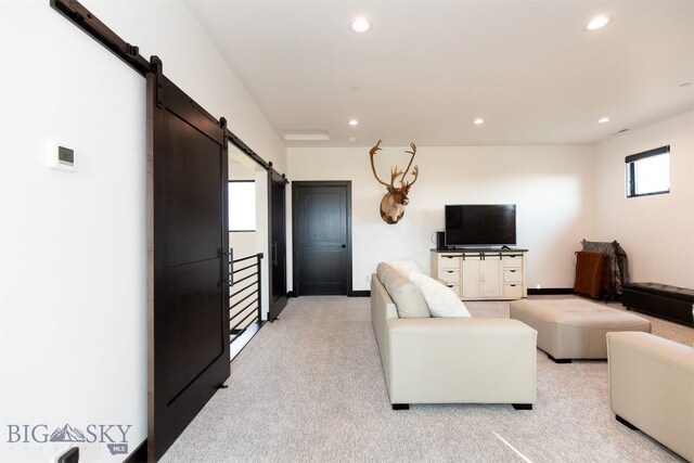 living room with light carpet and a barn door