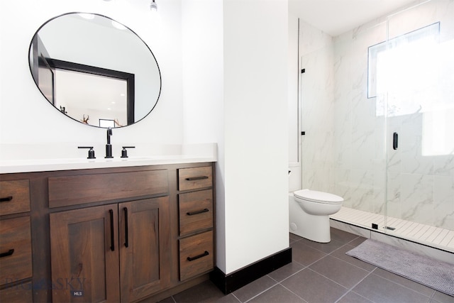 bathroom with vanity, toilet, tile patterned flooring, and walk in shower