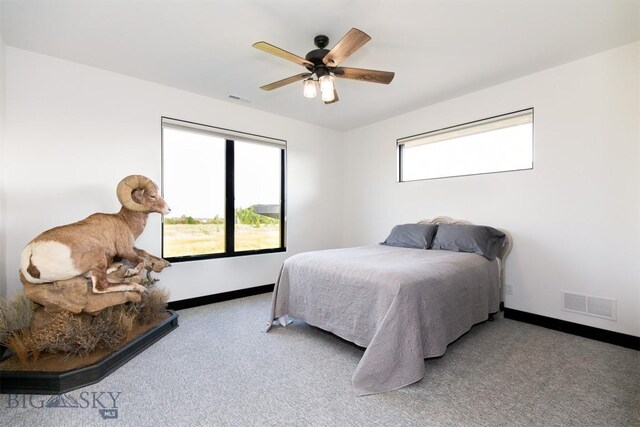 bedroom featuring light colored carpet and ceiling fan