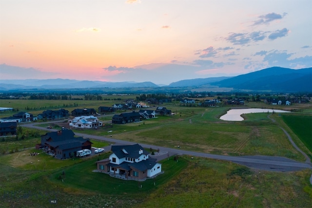 aerial view at dusk featuring a mountain view