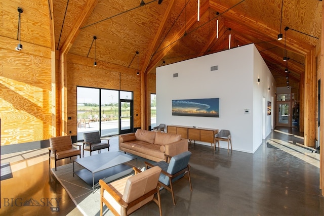 living room featuring high vaulted ceiling and concrete flooring