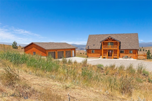 view of front of home with a deck and a garage