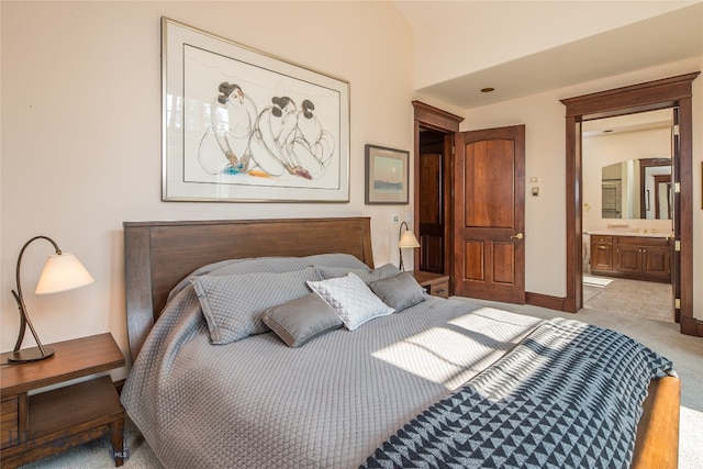 carpeted bedroom featuring connected bathroom