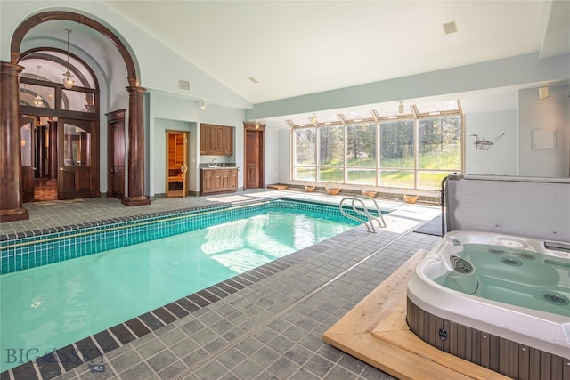 view of swimming pool featuring a hot tub and ornate columns