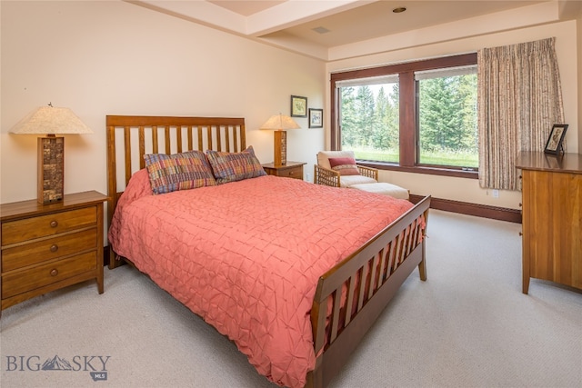 carpeted bedroom featuring beamed ceiling