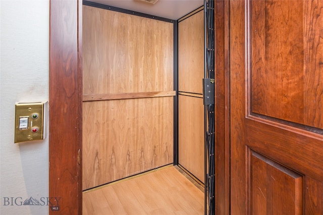 room details featuring elevator and hardwood / wood-style flooring