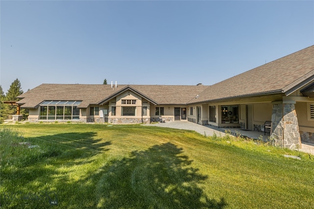 back of property with a patio and a yard