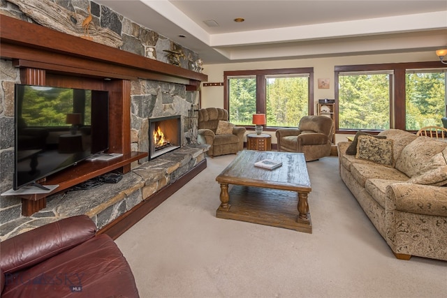 carpeted living room with a fireplace