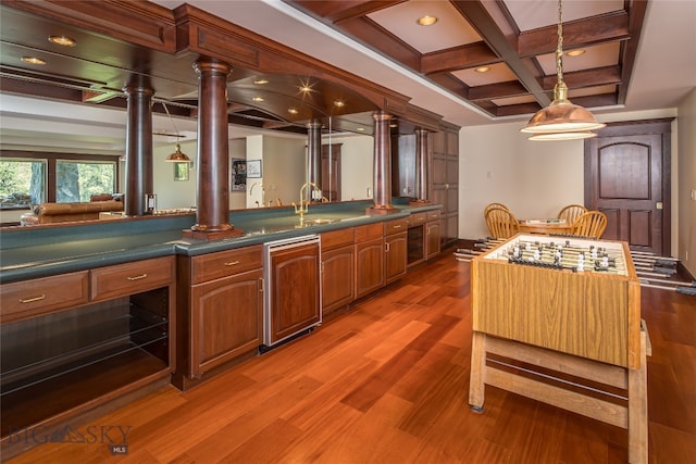 kitchen with wood-type flooring, hanging light fixtures, sink, coffered ceiling, and beamed ceiling