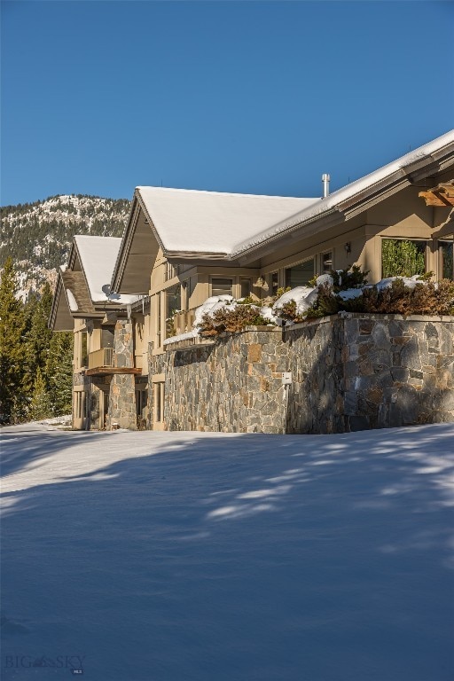 snow covered property featuring a mountain view