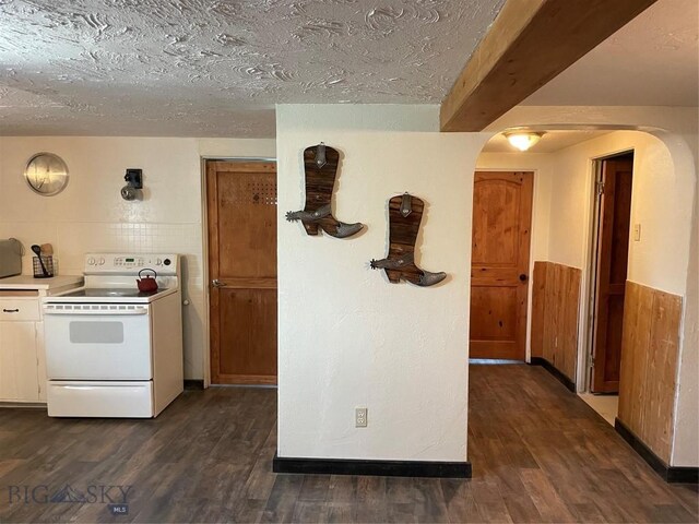 kitchen featuring dark wood-type flooring, white electric stove, and a textured ceiling