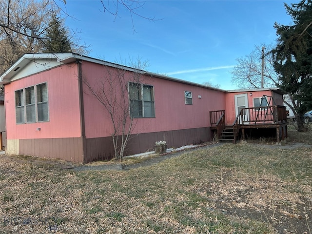 view of side of property with a wooden deck