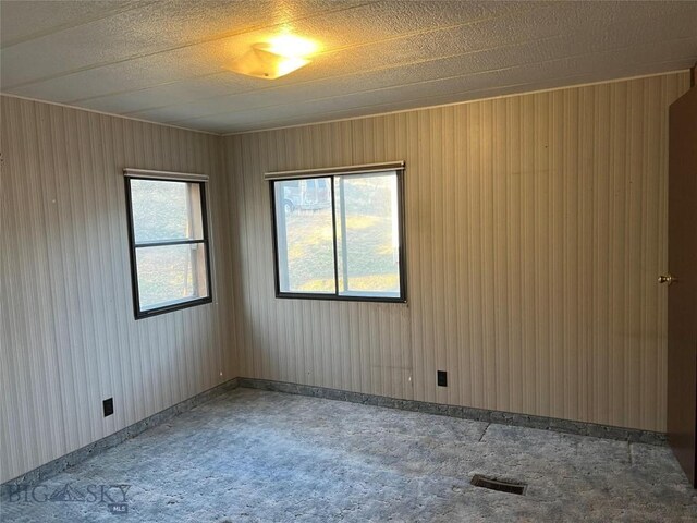 spare room with a textured ceiling