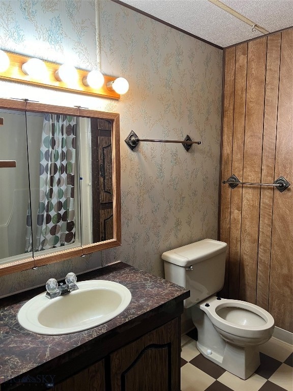 bathroom with vanity, toilet, tile patterned floors, and a textured ceiling