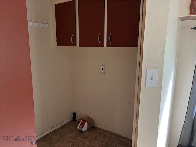 clothes washing area with cabinets, tile patterned floors, and electric dryer hookup