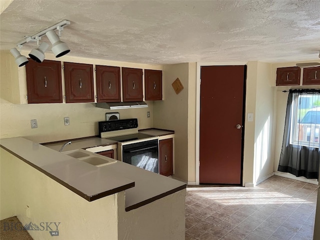 kitchen featuring light tile patterned flooring, white range with electric stovetop, sink, kitchen peninsula, and track lighting