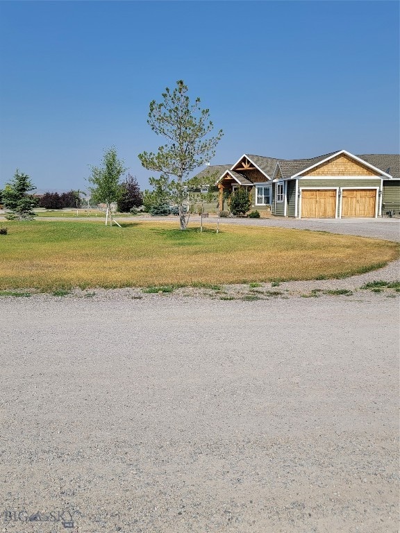 view of front of house with a front yard and a garage