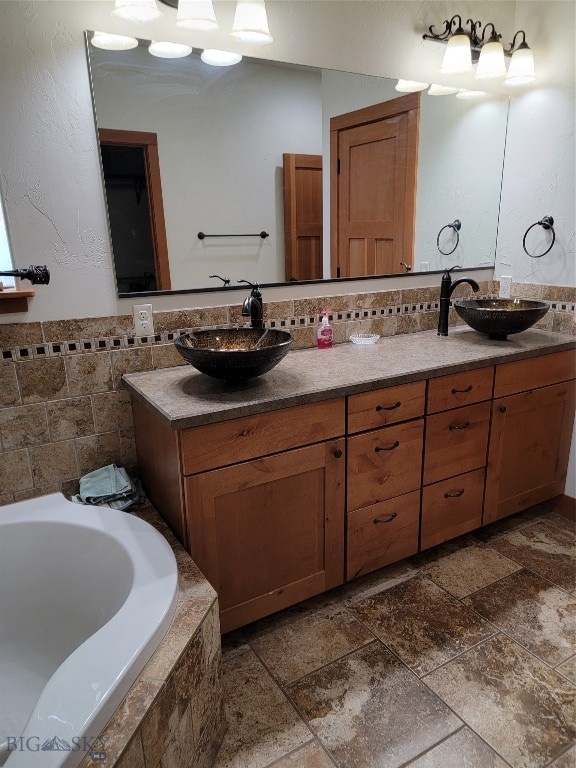 bathroom with tiled bath and vanity