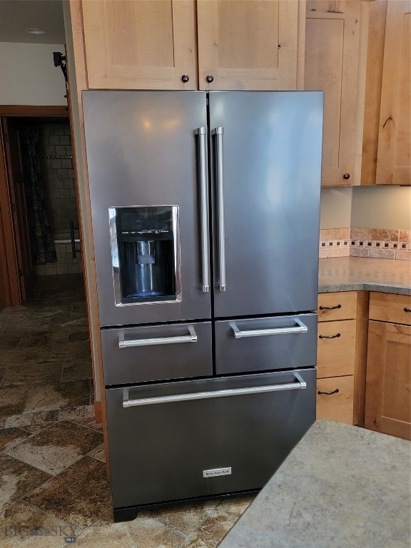 kitchen featuring light brown cabinets and high quality fridge