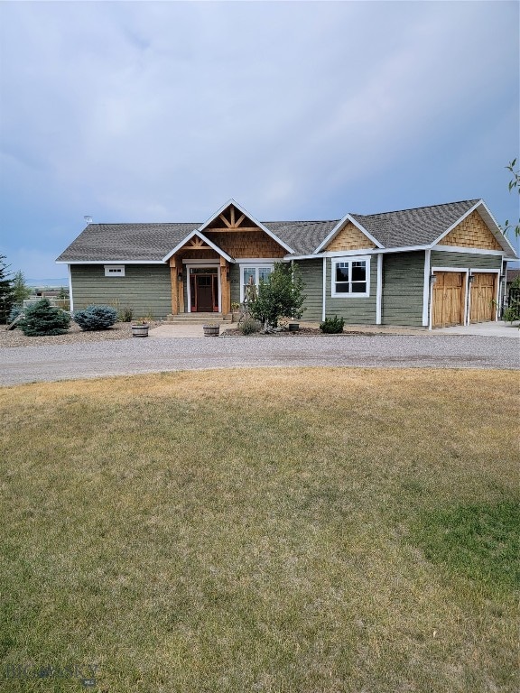 view of front of home with a garage and a front lawn