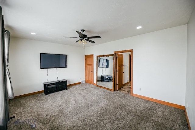 unfurnished living room featuring ceiling fan and carpet flooring