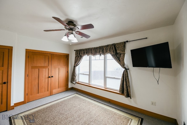 unfurnished bedroom with a closet, carpet, and ceiling fan